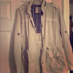 Light Grayish, trench coat, with a hood.